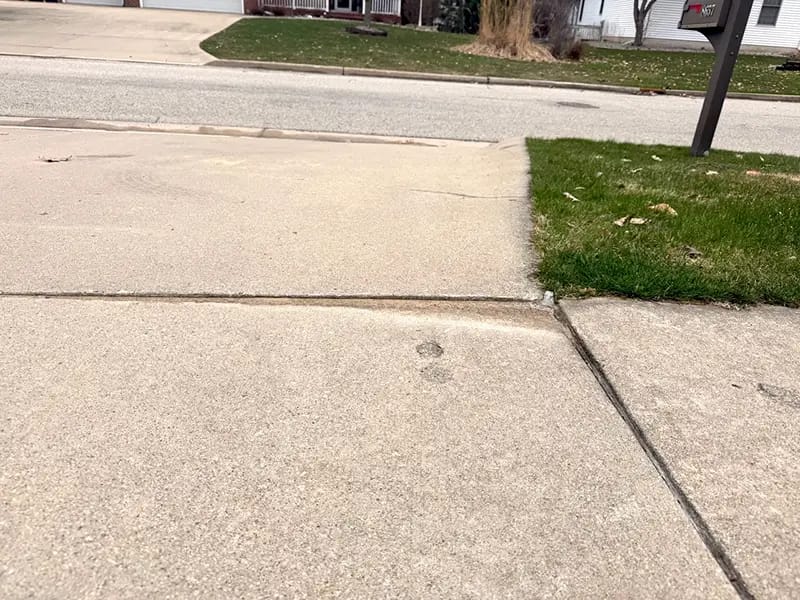Driveway & Adjacent Sidewalk Lifting in Lee’s Summit, MO Driveway & Adjacent Sidewalk Lifting in Lee’s Summit, MO
